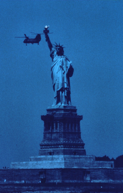 The Statue of Liberty, New York Harbor, with Navy helicopter during 1976 Bicentennial Tall Ship celebration