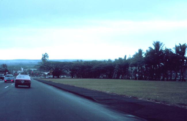 A view of Hilo at dusk with a snow-capped Mauna Loa in the background