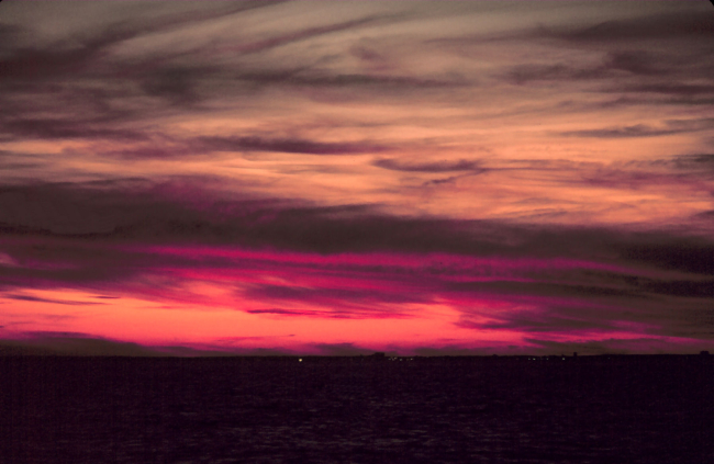 Lurid colors mark a sunrise at sea off the eastern seaboard