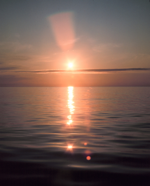 Brilliant reflection of sunlight off a calm ocean