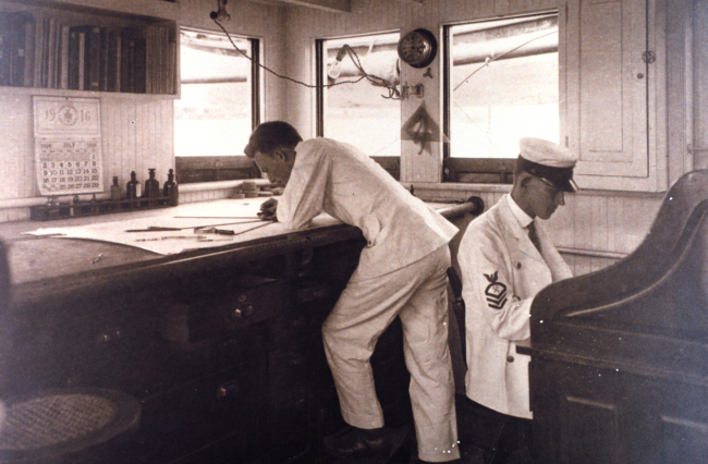 Working on a hydrographic survey smooth sheet on board the C&GS; Ship BACHEin July 1916