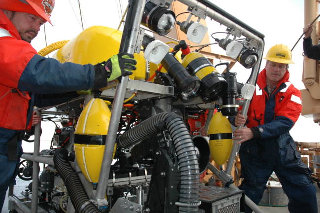 Mike Nicholson (left) and Joe Caba (right) move the ROVinto position for deployment