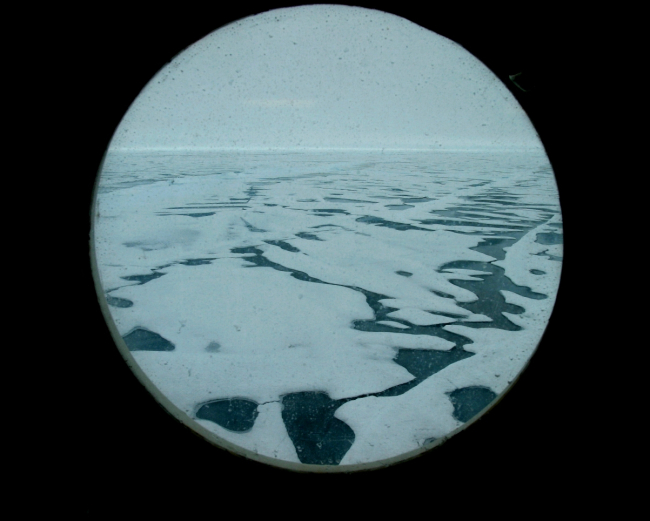 View of Arctic ice through one of Healy's portholes