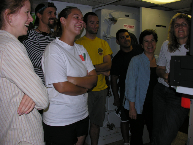 The exuberant science crew watching video footage of the chain cat shark