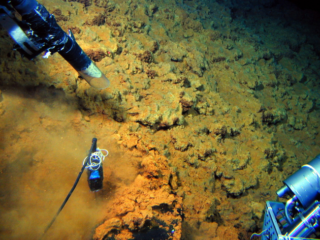 The suction sampler on PISCES V (upper left) vacuums up some orange microbialmat while a probe records the temperature (lower left) at Volcano W