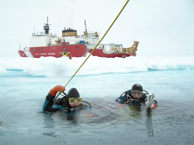Ice Divers Katrin Iken (left) and Elizabeth Calvert (right) are about todescend through a small hole in the ice and into the frigid world below