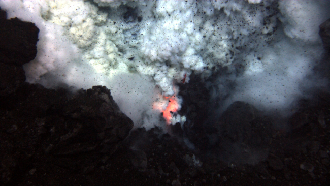 An explosion near the summit of West Mata volcano throws ash and rock,and molten lava glows below