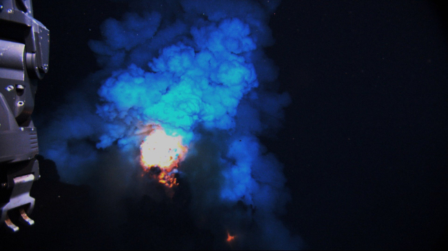 The eruption produces a bright flash of hot magma that is blown upinto the water before settling back to the seafloor