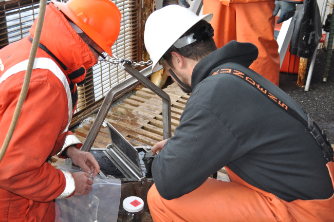 Inspecting the contents of a bottom sample on the NOAA Ship MILLER FREEMAN