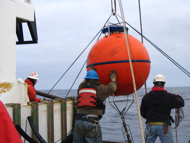 Deploying oceanographic buoy from stern of NOAA Ship MILLER FREEMAN