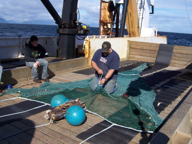Mending a net on the NOAA Ship MILLER FREEMAN