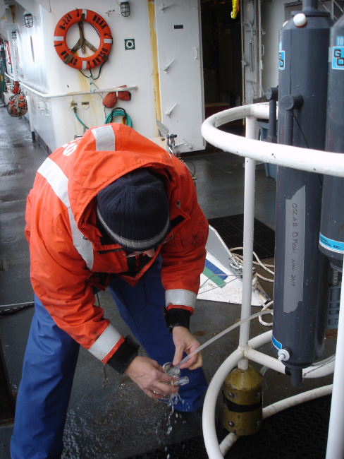 Collecting oxygen sample from depth controlled Nansen bottle opening