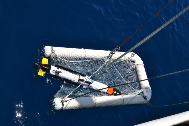 An autonomous underwater vehicle being lowered to the water prior tosending on its maiden mapping voyage