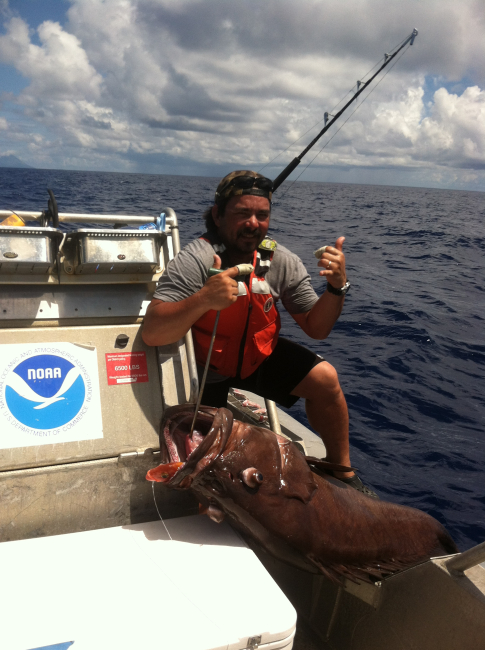 Tony Flores shows the impressive size of this eight-banded grouper
