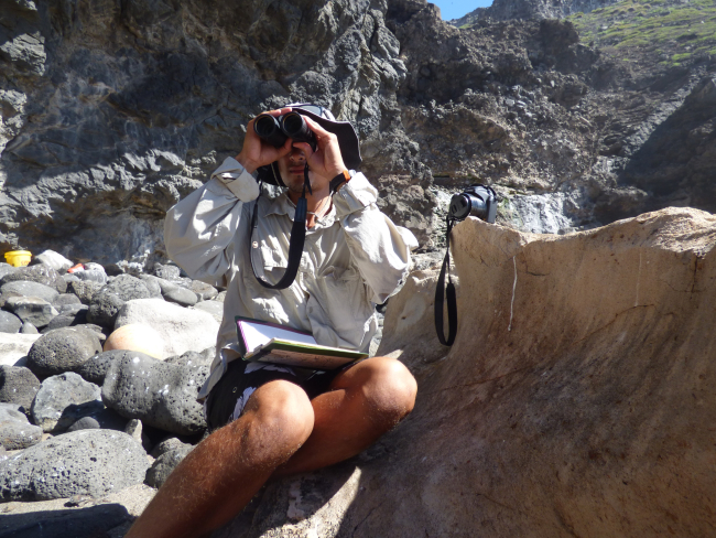 Field researcher Keelan Barcina surveying for monk seals on Nihoa Island