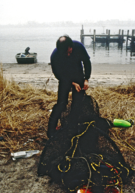 Mark Myers (NOAA Fisheries, NWFSC) is mending a trawl net used to collect winter flounder for chemical analyses
