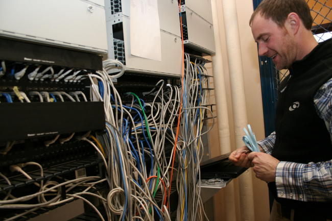 IT specialist Barry Semple manages network cables at Montlake FisheriesLaboratory