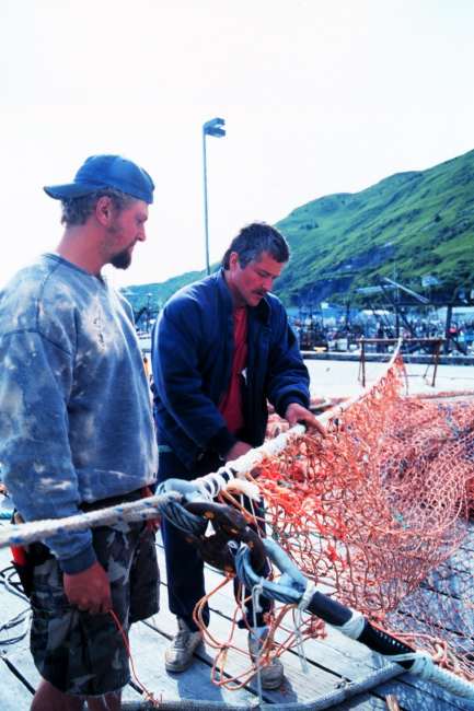 Fishermen mending nets at St