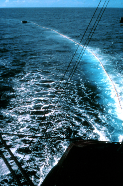 Workboat holding net prior to ship encircling school of tuna