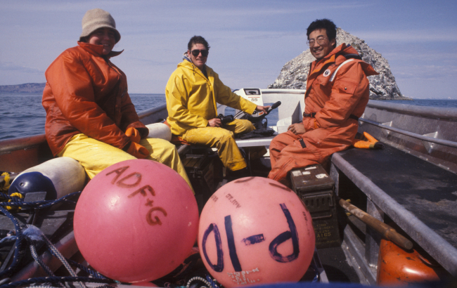 Beth Haley and Kevin Brennan with Allen Shimada approaching offshore rock inTogiak area during offshore herring roe survey