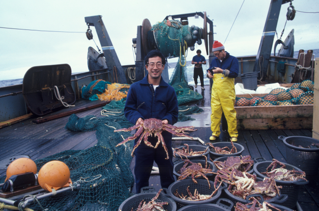 Allen Shimada showing king crab caught in Bering Sea on research cruise