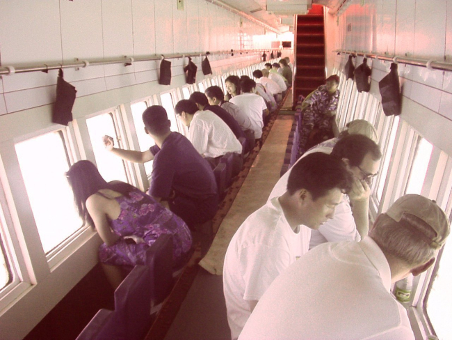 American and Chinese scientists touring Hainan sea in glass bottom boat