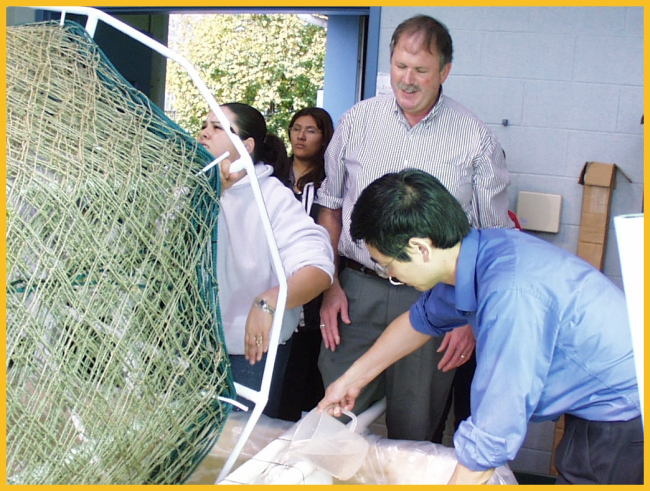 Algae spores being added to the soup for growth on hand-made nets