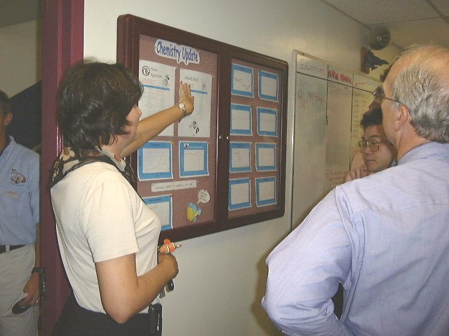 Epcot Living Seas Aquarist, Jane Davis shows bulletin board wherechemistry data for the aquarium is kept