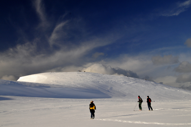 Scientists hiking across a glacier