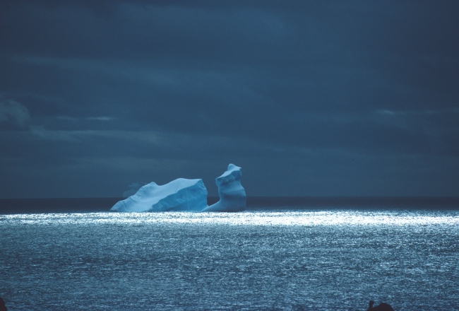 A grounded iceberg called a growler, sculpted by wind and waves