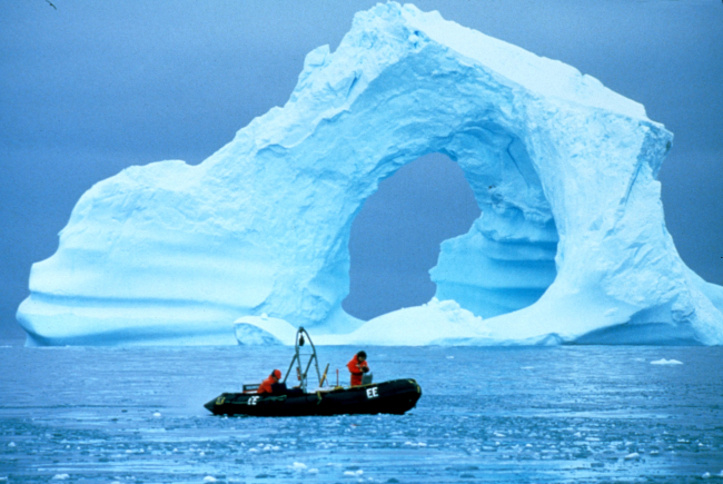 Driving a Zodiac past a spectacular iceberg