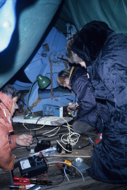 Polish electronics technician Emil Ociepka, John Wormuth and John Green workunder a makeshift tent on the deck of the R/V Profesor Siedlecki, terminatingthe electronics of Wormuths' Multiple Opening and Closing Net andEnvironmental Sensing System (MOCNESS)
