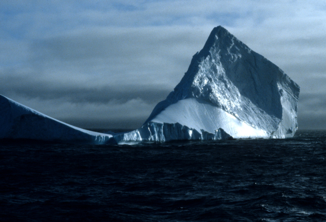 A tabular iceberg, being reshaped by the wind and ocean