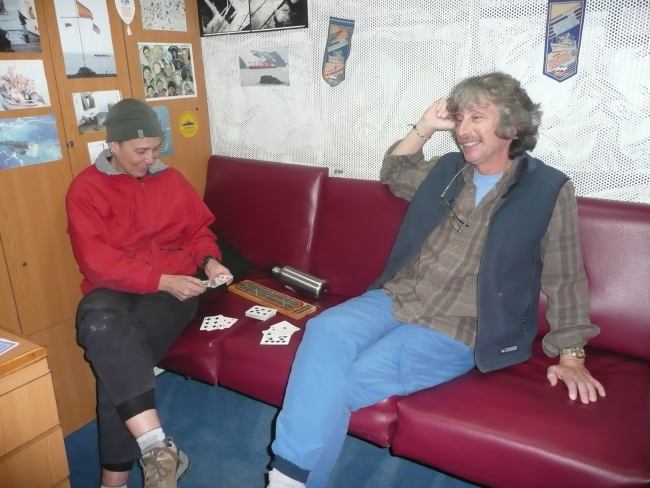 Zooplankton expert Kimberly Dietrich and veteran seabird observer MikeForce relax on the R/V Yuzhmorgeologiya by playing cribbage