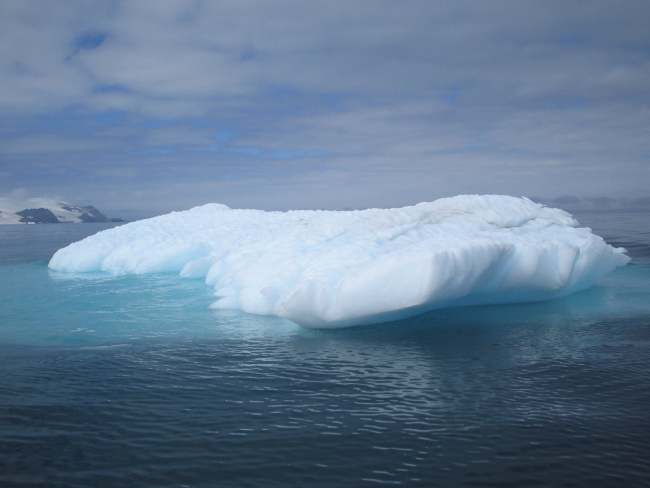 An iceberg, with most of its mass clearly visible underwater