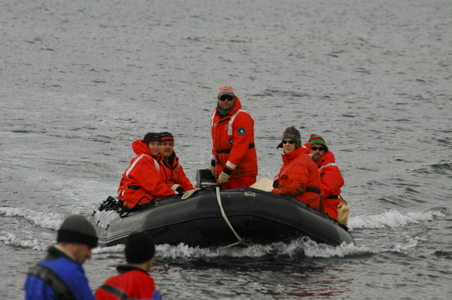 AMLR Program scientists bring supplies to the Copacabana field camp using aZodiac inflatable boat