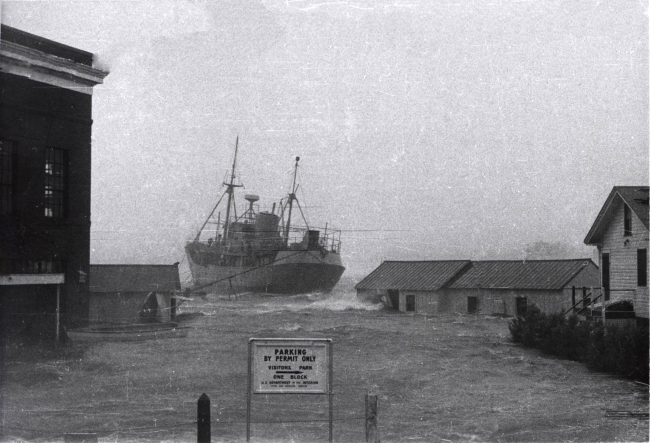 ALBATROSS III breaking free from pier during Hurricane Carol