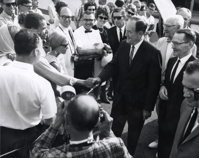 Vice President Hubert Humphrey shaking the hand of Conservation AidElwin Cotman