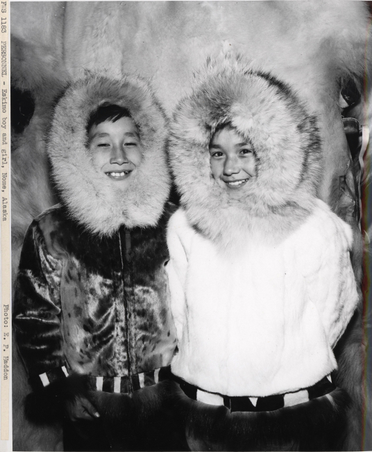 Eskimo boy and girl with fur-trimmed parkas