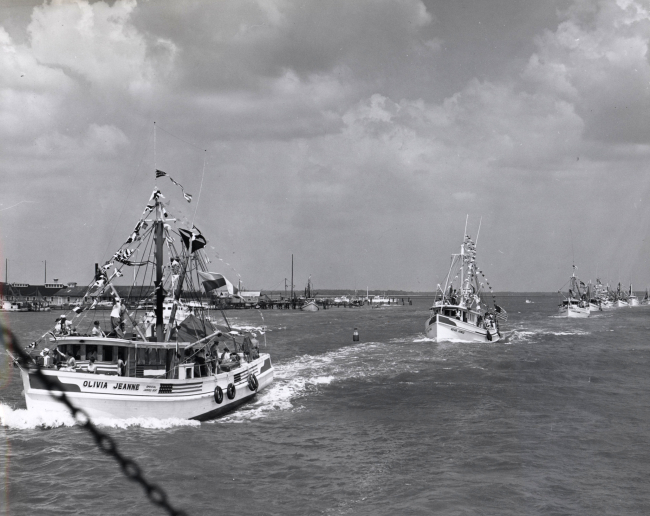 Parade of shrimp boats and other fishing vessels at the Annual Blessing of theFleet