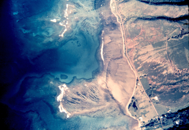 Aerial photograph of tropical island shoreline showing reefs and otherunderwater features