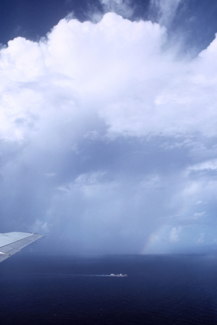A tanker sailing through the tropical Atlantic with a rainbow in the distance
