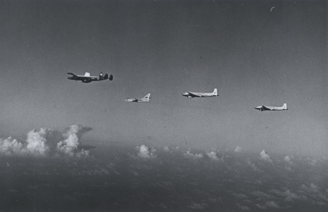 Two ESSA DC-6's, a United States Air Force B-47, and a United States NavyWV-3 Super Constellation flying over fair weather cumulus, possiblyen route to hurricane as part of Hurricane Research Project