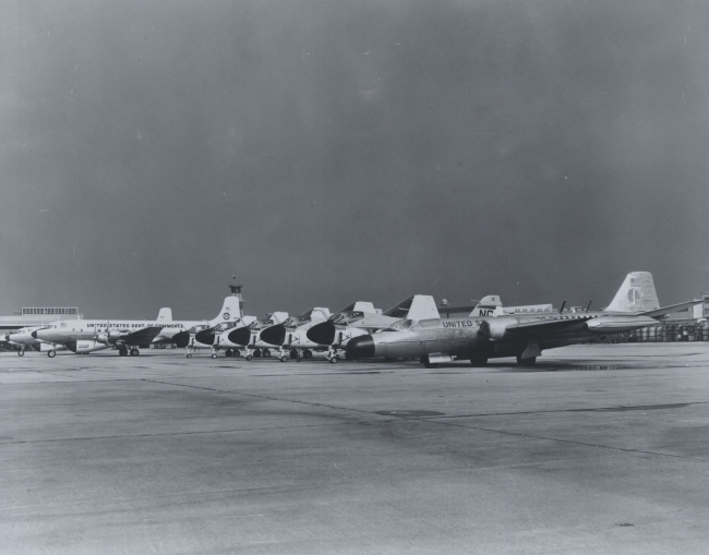 Weather Bureau DC-6's to left and Weather Bureau B-57 on right flanking militaryaircraft