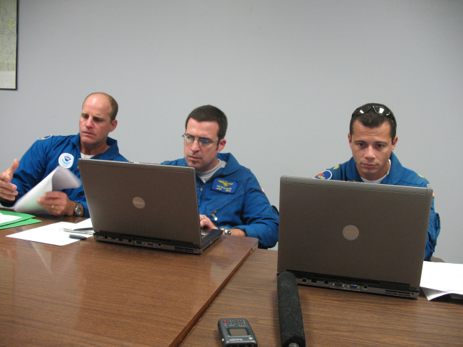 LCDR Tim Gallagher in center while planning mission into hurricane Ike