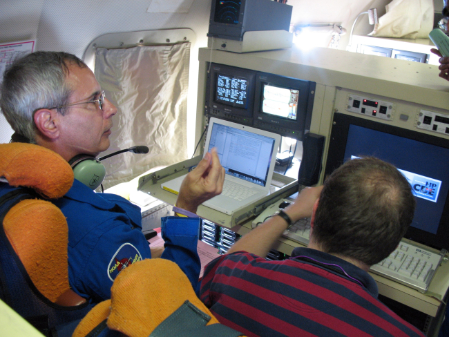 Scientific personnel monitoring computers and instruments during flight intoHurricane Ike