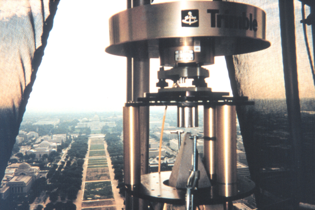 A GPS receiver sits astride the apex of the Washington Monument