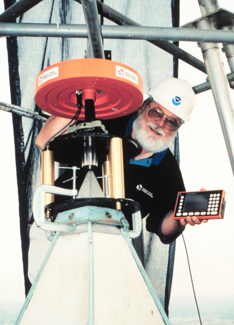 A Spectra Precision GPS antenna atop the Washington Monument withEllis Veatch of Spectra Precision