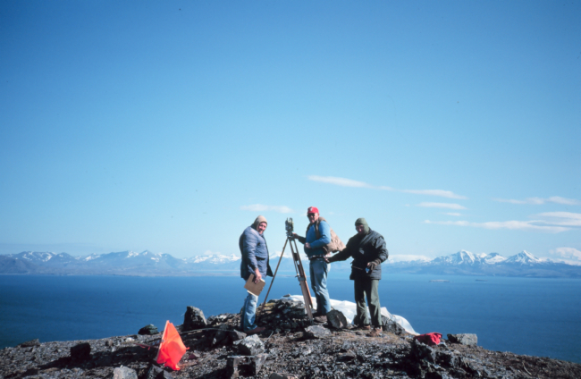 Last of the old-timers - Dennis Wegenast, Lyle Riggers, and Sander Feher onhigh point of Sutwik Island setting up T-2 theodolite