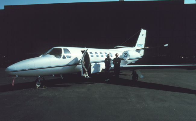 Photogrammetrist Bill Hawken and Commander Bob McCann standing byNOAA Cessna Citation II N52RF at Dulles International Airport